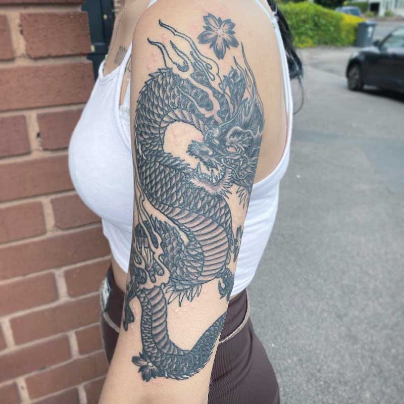 Japanese style black dragon tattoo on the right