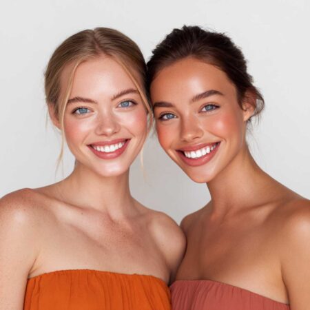 A photo of two smiling, beautiful skincare models