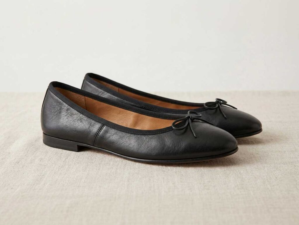 Pair of ballet flats with a rounded toe and low-cut opening on a neutral background