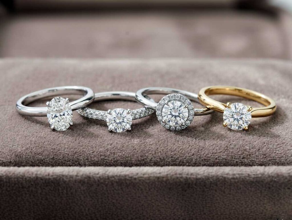 Close-up of engagement rings in different styles arranged on a neutral surface for online comparison